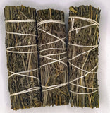 Three bundles of tied lavender on a white background