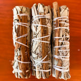white_sage_cinnamon_smudge_stick_wood_background