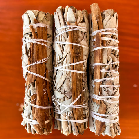 white_sage_cinnamon_smudge_stick_wood_background
