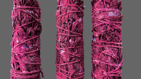 Three red smudge sticks on a gray background 